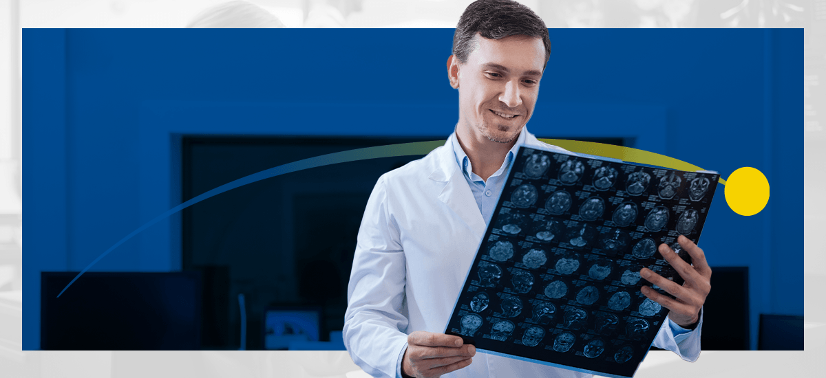 A radiologist looks at a sheet of brain images