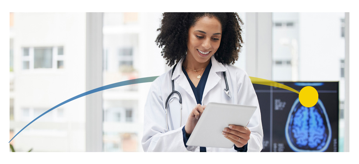 A female doctor looks at a tablet